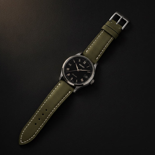 Wichtelmänner Olive Green leather watch strap fitted to a black-dial dress watch